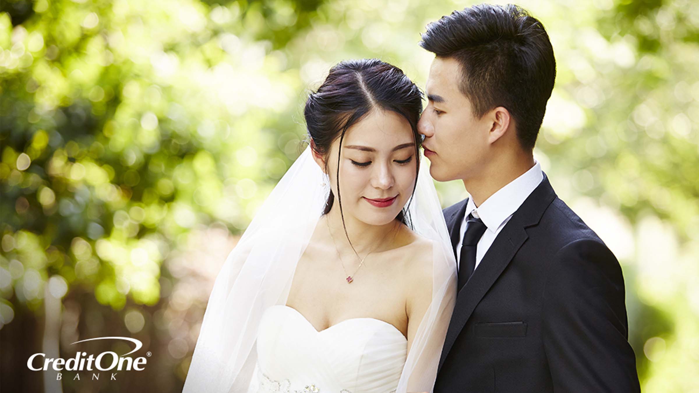 A young bride and groom embracing each other on their wedding day